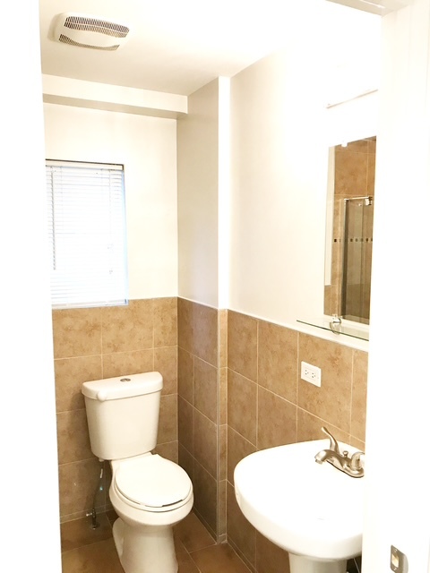 1356 North Cleveland Avenue, Unit 2 Chicago, IL 60610 - Photo 13 of 15 a bathroom with a toilet a sink and mirror