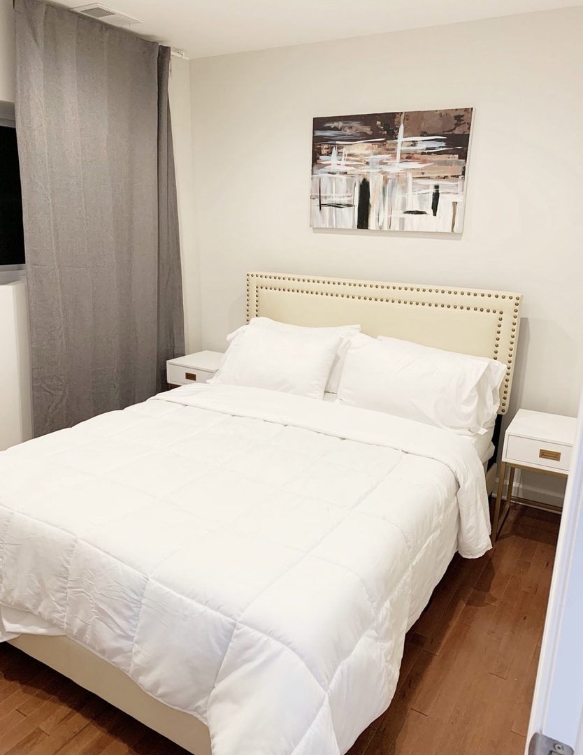 1356 North Cleveland Avenue, Unit 2 Chicago, IL 60610 - Photo 4 of 15 a bedroom with a bed and a night stand