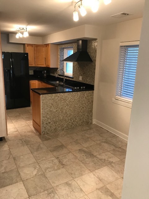 1356 North Cleveland Avenue, Unit 2 Chicago, IL 60610 - Photo 6 of 15 a view of kitchen with stainless steel appliances granite countertop a sink and a refrigerator