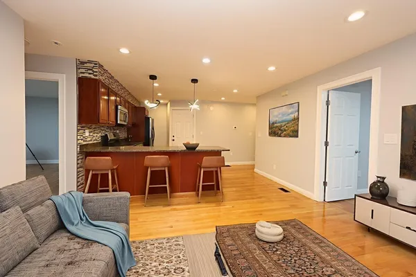 a living room with furniture and wooden floor