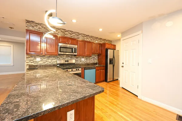 a kitchen with stainless steel appliances granite countertop a sink and stove