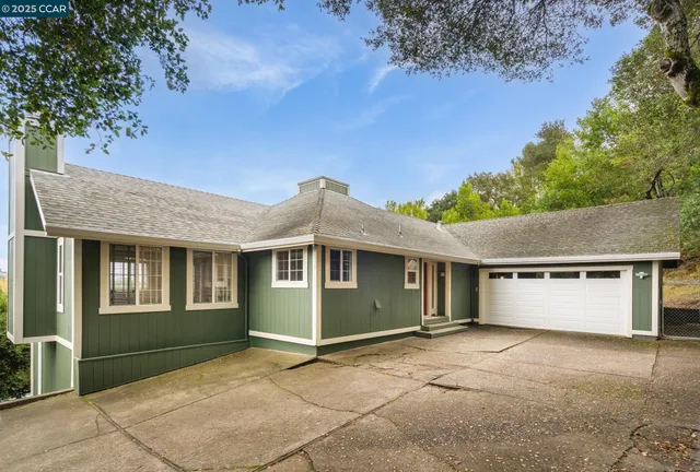 a view of house with outdoor space and a garage