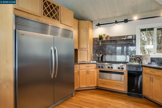 a kitchen with stainless steel appliances granite countertop a stove and a microwave