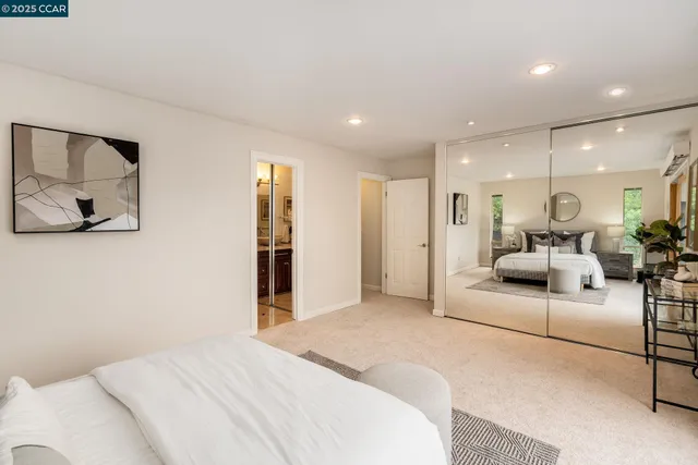 a bathroom with a granite countertop shower sink vanity mirror and toilet