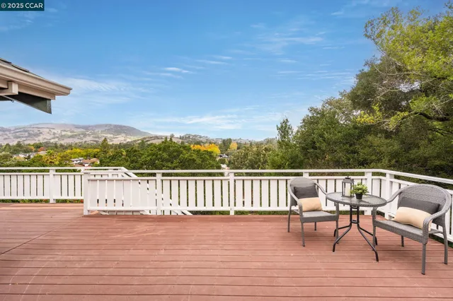 a aerial view of a house with a yard table and chairs