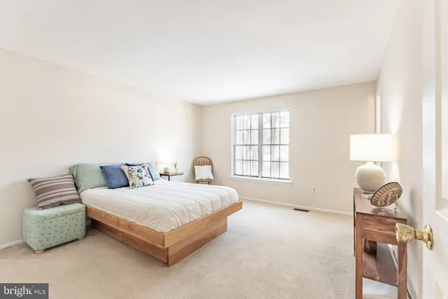 a bedroom with a bed and a lamp