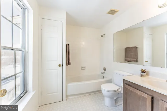 a view of a house with a wooden fence