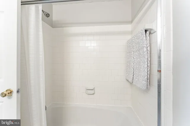 a view of a swimming pool with a table and chairs under an umbrella
