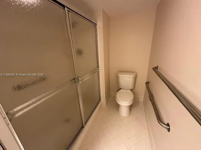 a bathroom with a toilet and a shower
