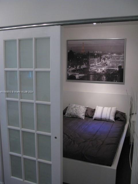 1525 Meridian Avenue, Unit 207 Miami Beach, FL 33139 - Photo 11 of 18 a living room with a bed and a painting on the wall