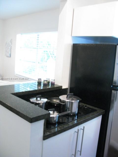 1525 Meridian Avenue, Unit 207 Miami Beach, FL 33139 - Photo 14 of 18 a kitchen with a sink and a stove