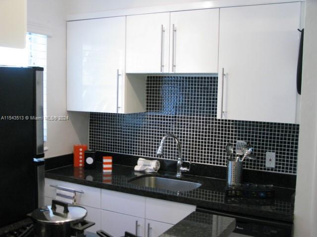 1525 Meridian Avenue, Unit 207 Miami Beach, FL 33139 - Photo 6 of 18 a bathroom with a sink and a mirror