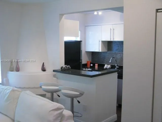 a living room with furniture and a lamp