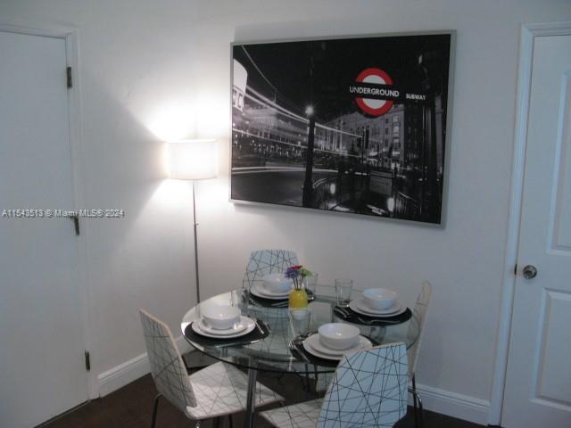 1525 Meridian Avenue, Unit 207 Miami Beach, FL 33139 - Photo 10 of 18 a table and chairs in a kitchen