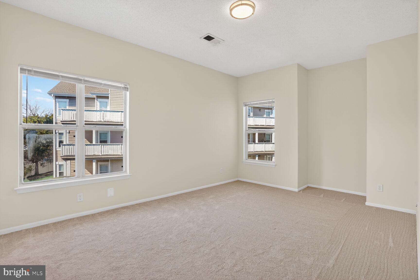 14322 Climbing Rose Way, Unit 306 Centreville, VA 20121 - Photo 13 of 35 a view of an empty room with a window