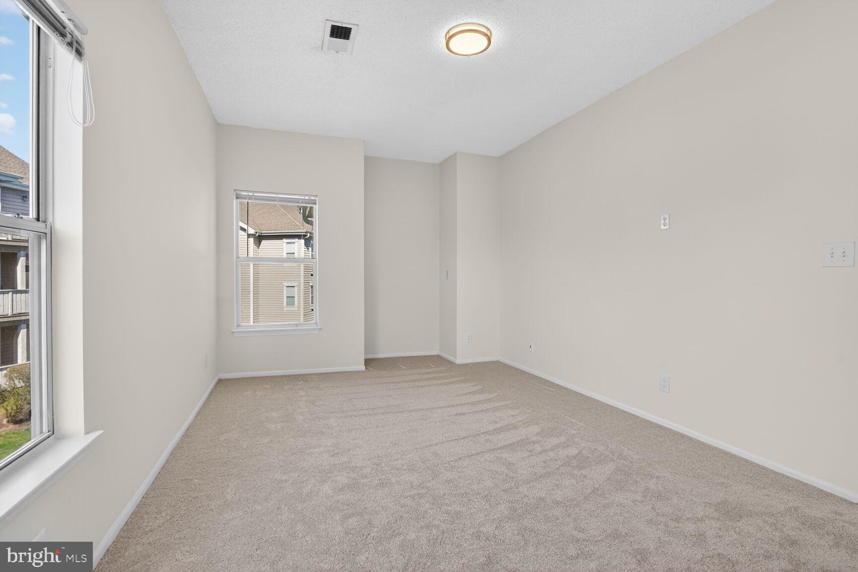 14322 Climbing Rose Way, Unit 306 Centreville, VA 20121 - Photo 14 of 35 an empty room with windows