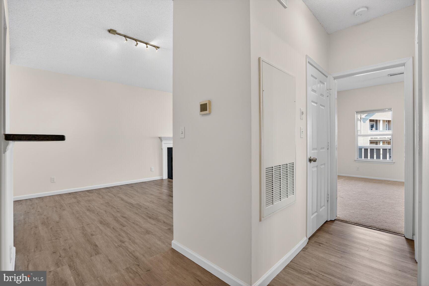 14322 Climbing Rose Way, Unit 306 Centreville, VA 20121 - Photo 17 of 35 a view of a hallway with wooden floor