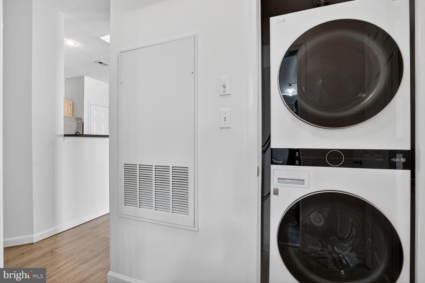 14322 Climbing Rose Way, Unit 306 Centreville, VA 20121 - Photo 21 of 35 a view of a hallway with washer and dryer