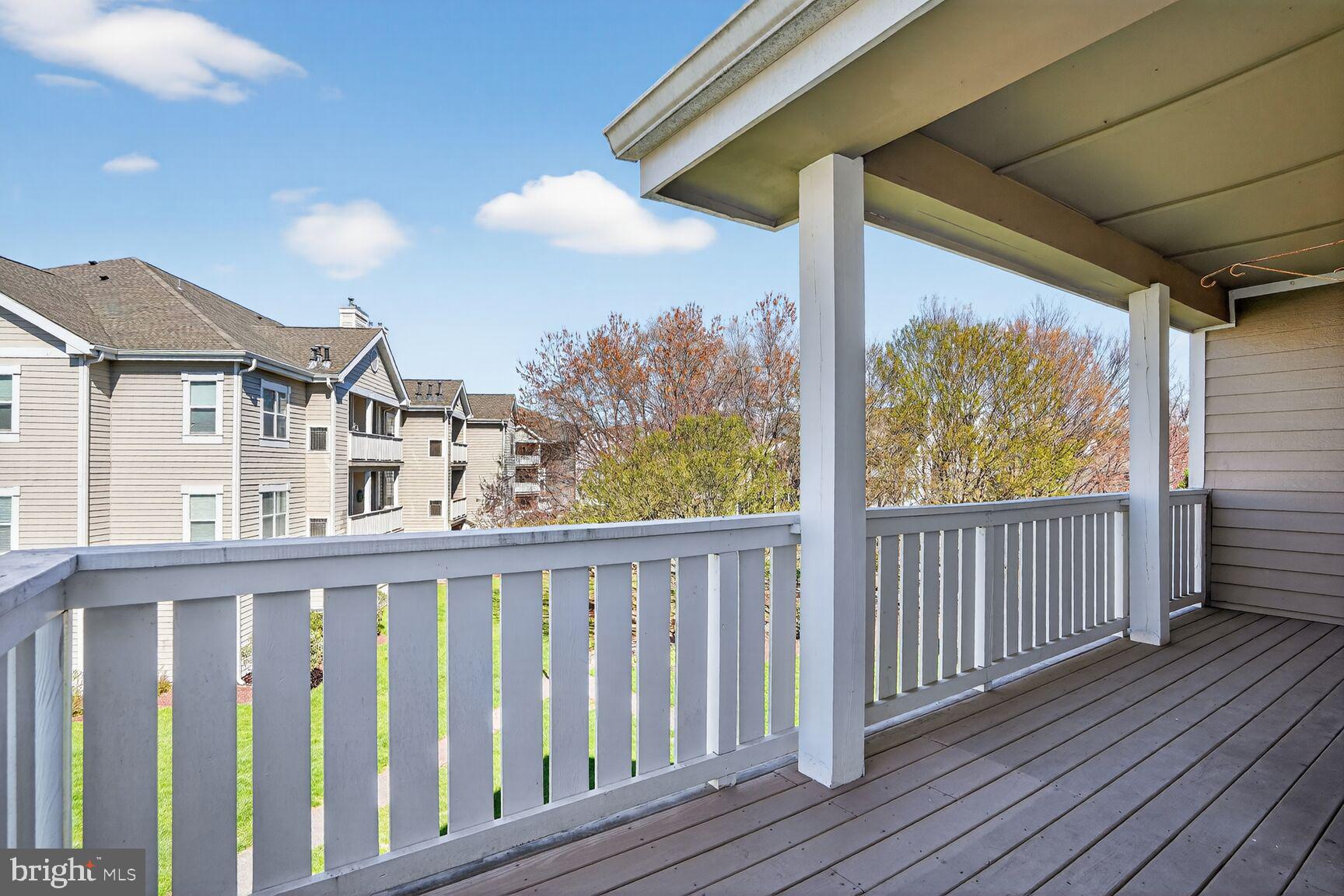 14322 Climbing Rose Way, Unit 306 Centreville, VA 20121 - Photo 22 of 35 a view of a balcony with wooden floor