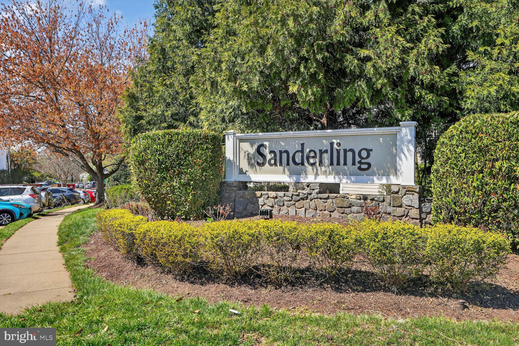 14322 Climbing Rose Way, Unit 306 Centreville, VA 20121 - Photo 24 of 35 a view of a street sign under a large tree