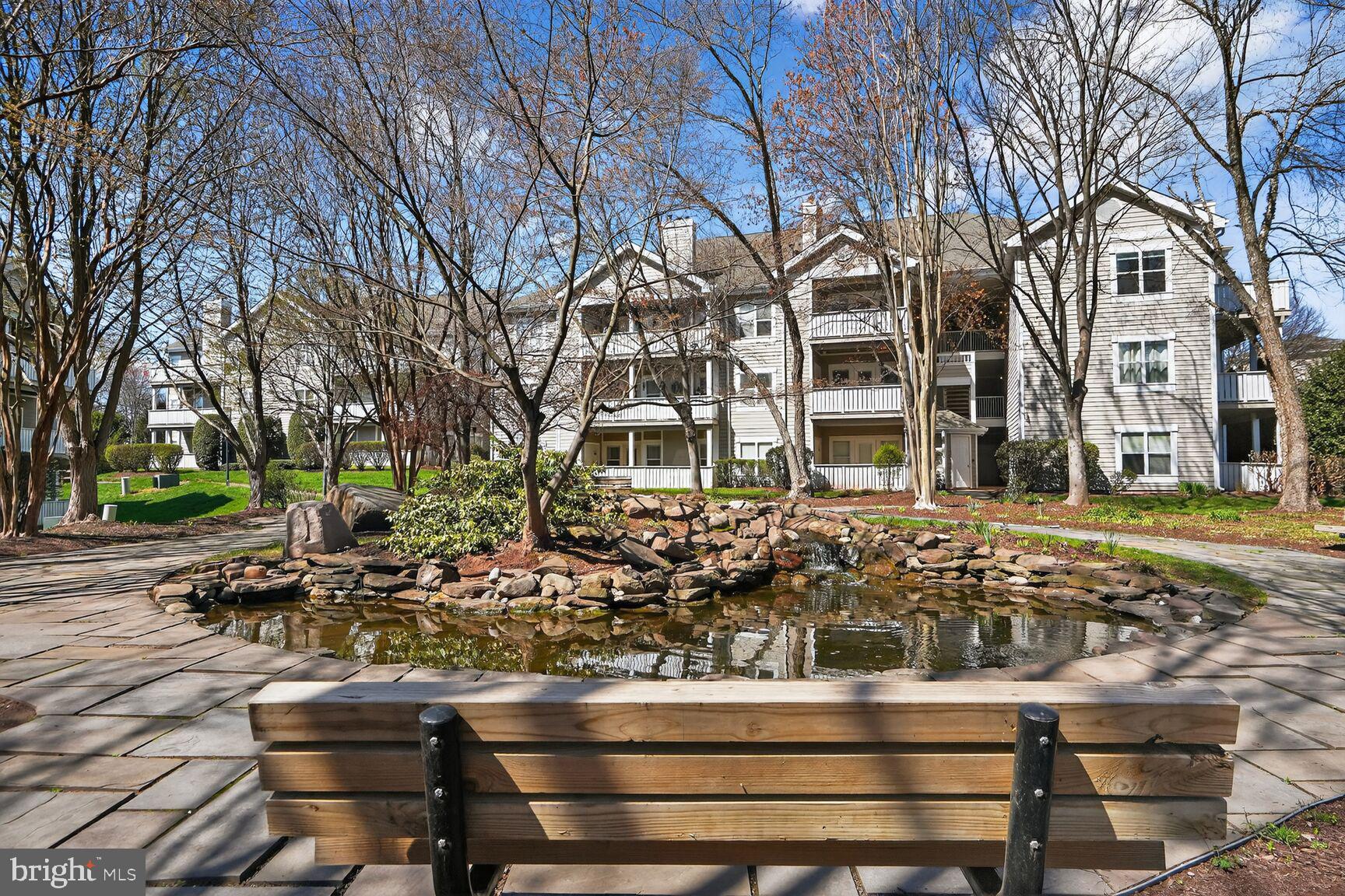 14322 Climbing Rose Way, Unit 306 Centreville, VA 20121 - Photo 25 of 35 a front view of a building with trees
