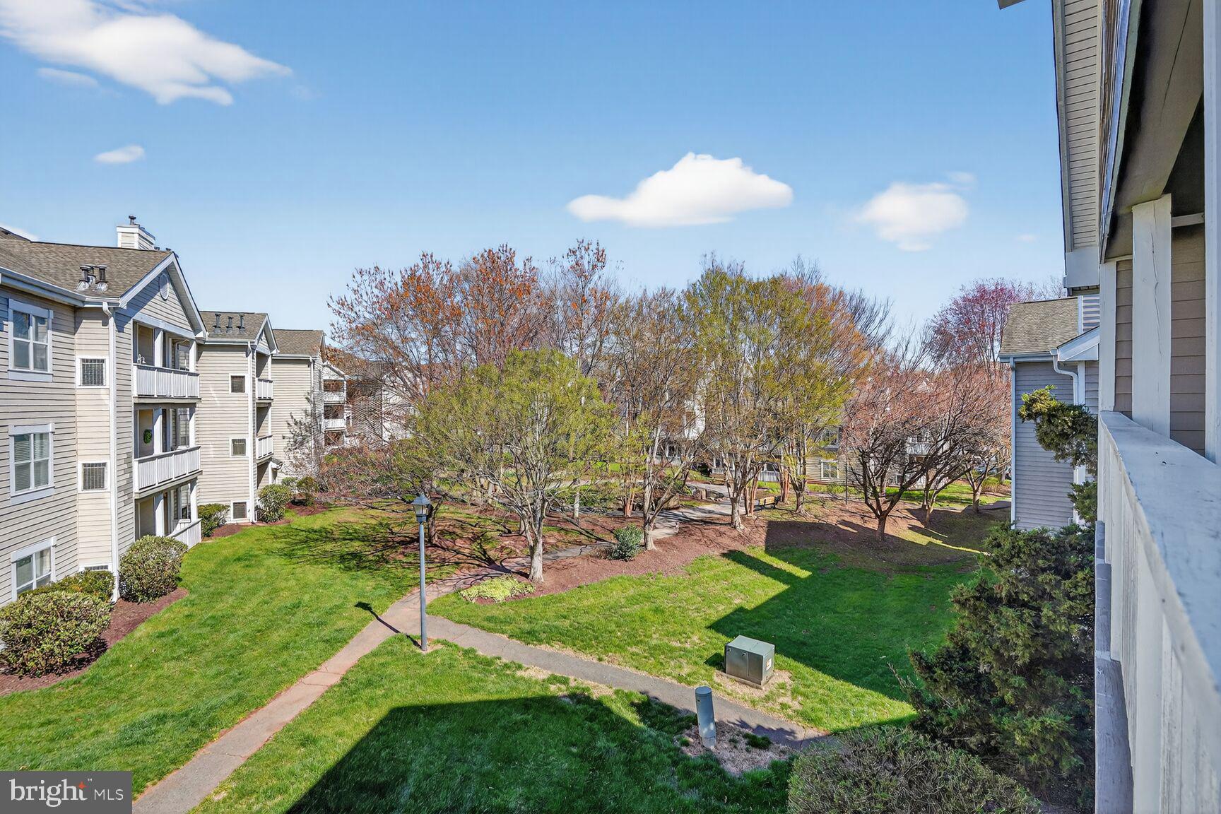 14322 Climbing Rose Way, Unit 306 Centreville, VA 20121 - Photo 27 of 35 a view of a building with a yard and a fountain