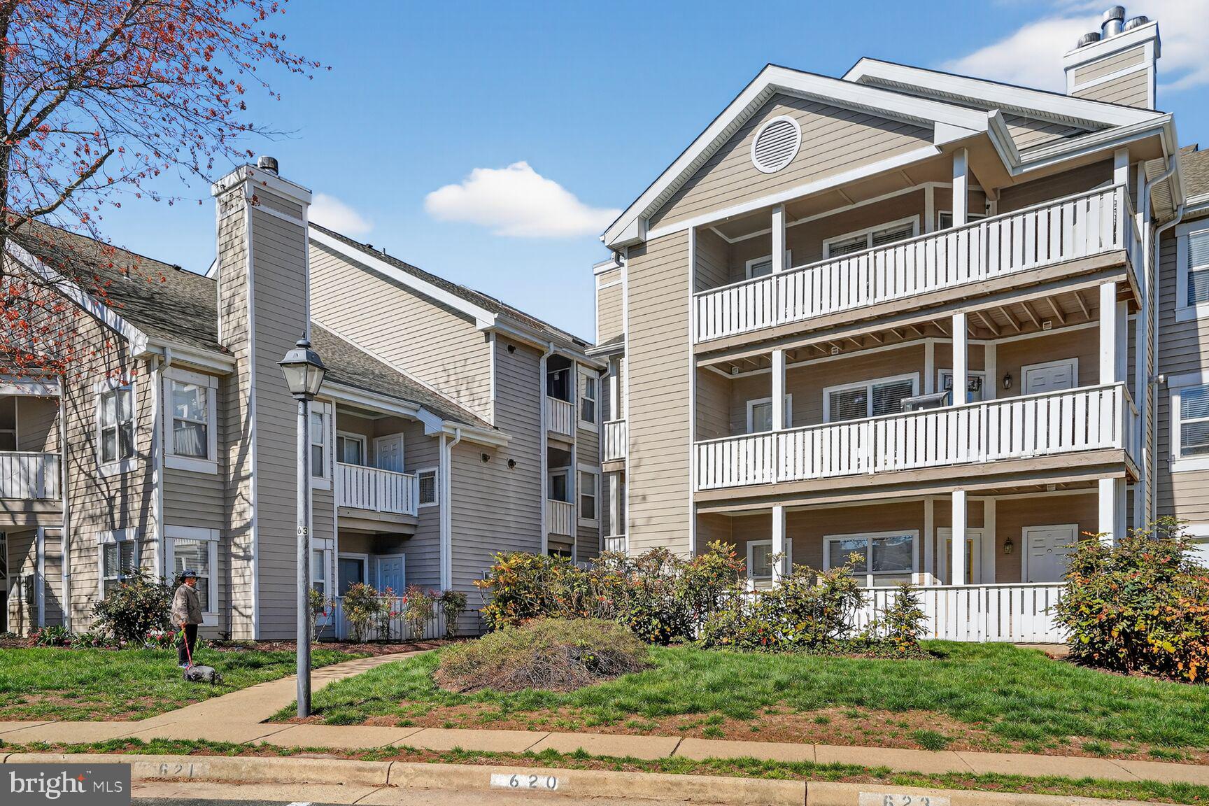14322 Climbing Rose Way, Unit 306 Centreville, VA 20121 - Photo 28 of 35 a front view of a building with garden