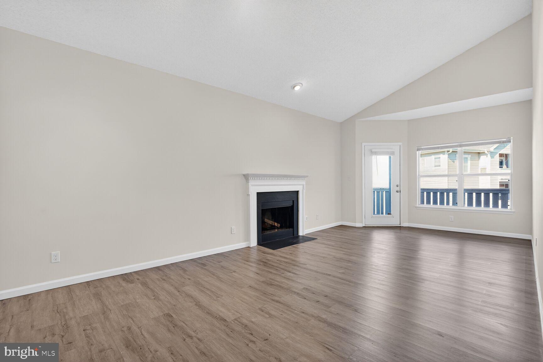 14322 Climbing Rose Way, Unit 306 Centreville, VA 20121 - Photo 5 of 35 a view of an empty room with wooden floor and a window