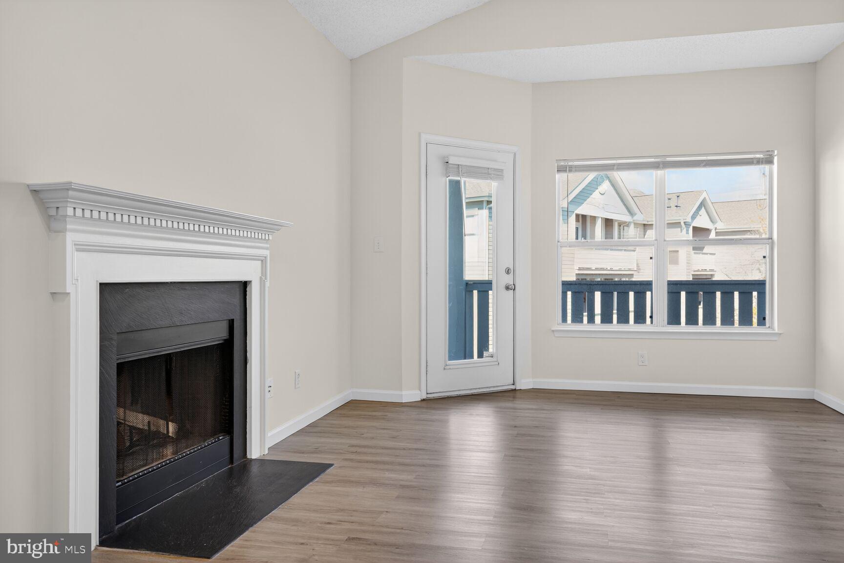 14322 Climbing Rose Way, Unit 306 Centreville, VA 20121 - Photo 7 of 35 a view of an empty room with wooden floor and a window