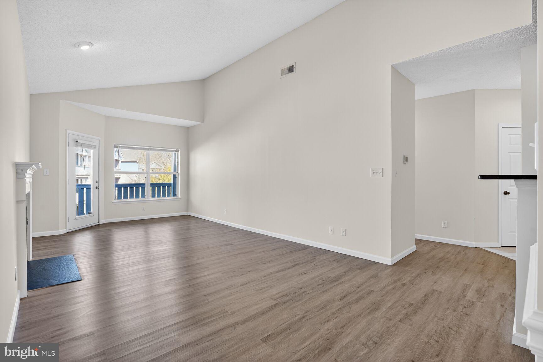 14322 Climbing Rose Way, Unit 306 Centreville, VA 20121 - Photo 8 of 35 wooden floor in an empty room with a window