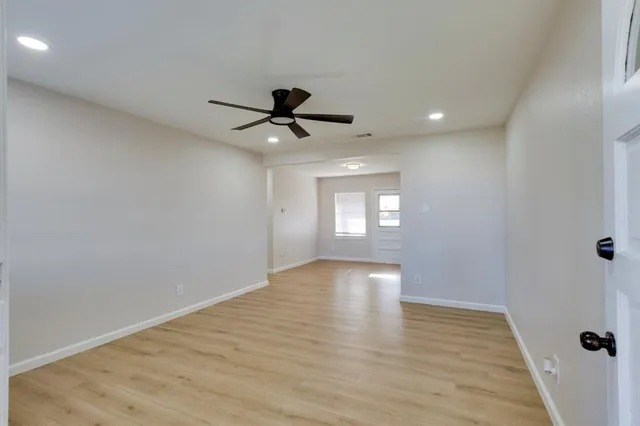 a view of an empty room and wooden floor