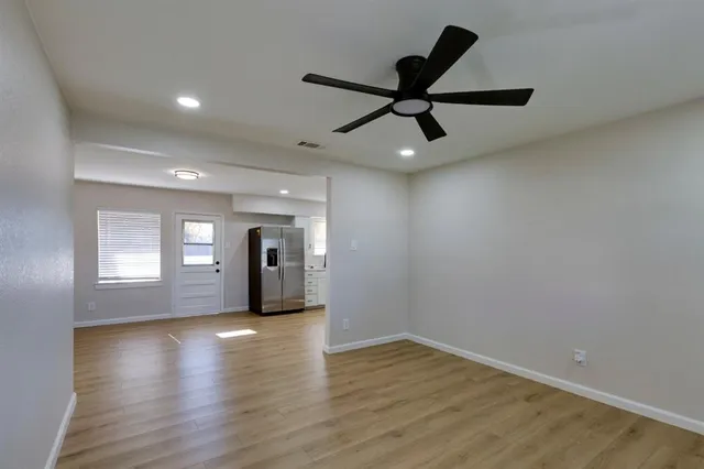 a view of a room with wooden floor and windows