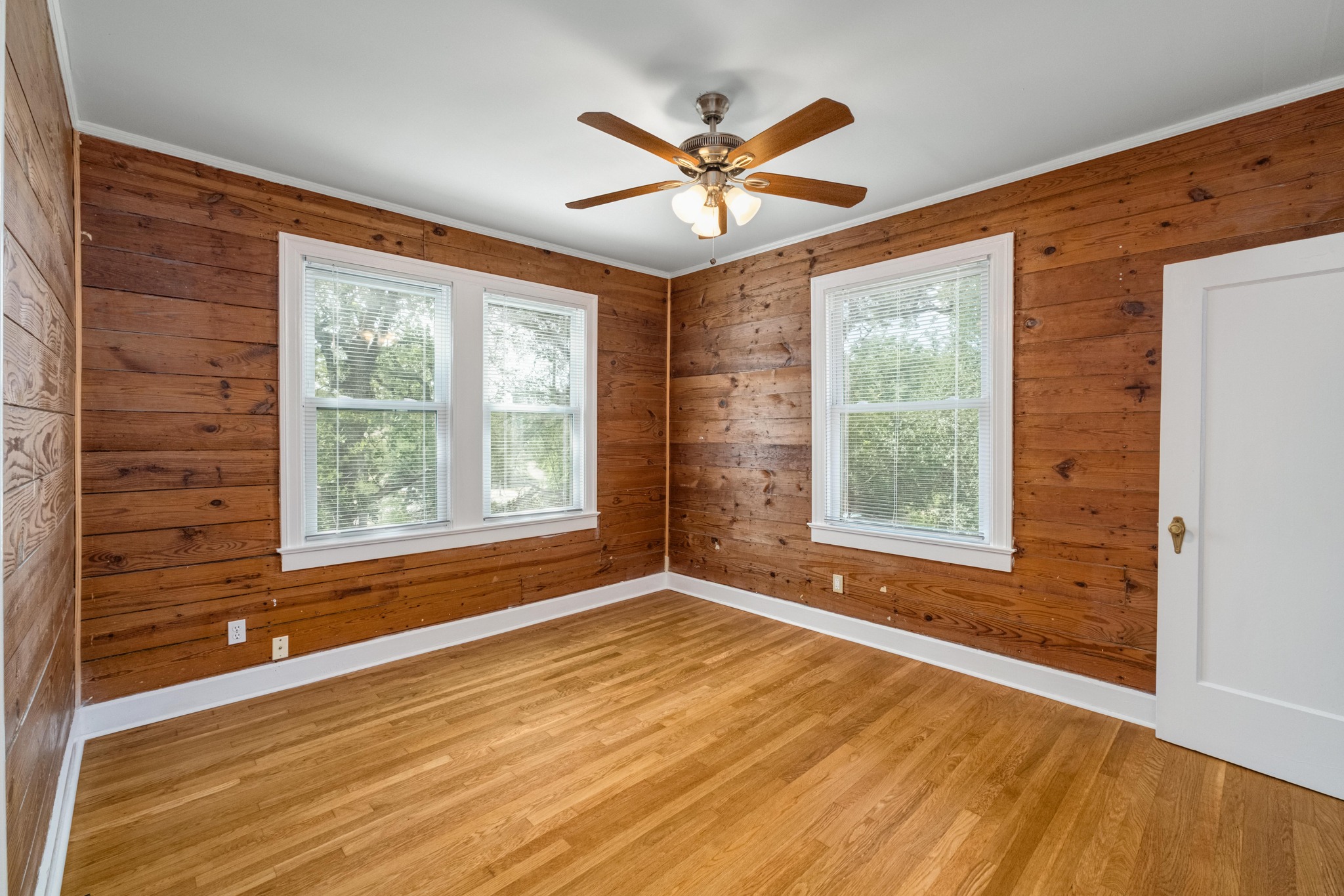 2012 Enfield Road, Unit B Austin, TX 78703 - Photo 11 of 20 Natural wood paneling and bright windows illuminate this cozy, inviting bedroom.