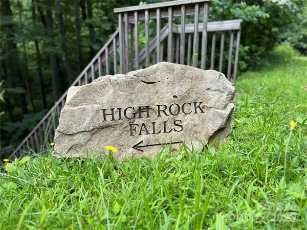 a balcony with lots of green trees