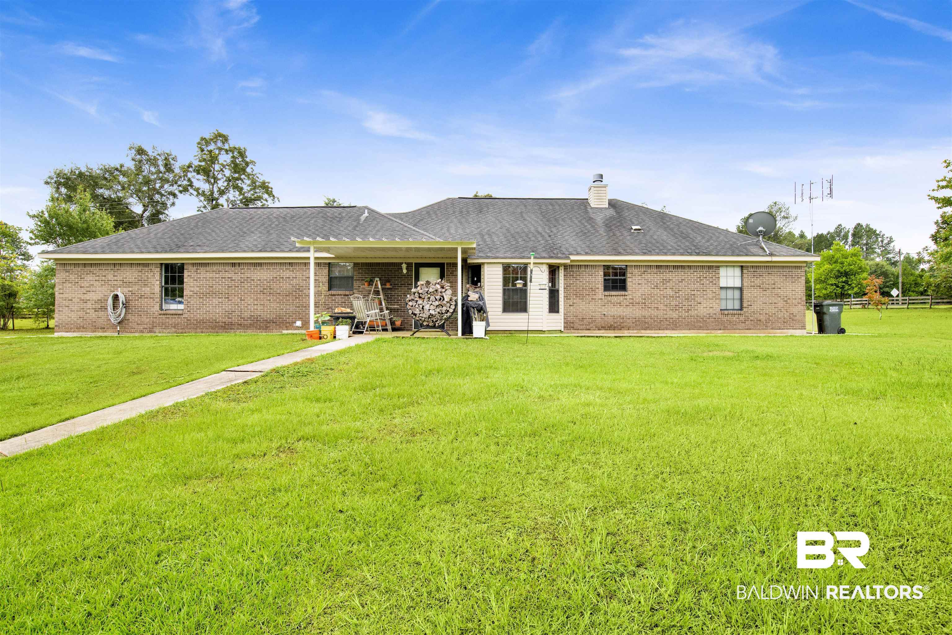 54563 Splinter Hill Road Perdido, AL 36562 - Photo 7 of 29 Back of property with a yard and a patio area