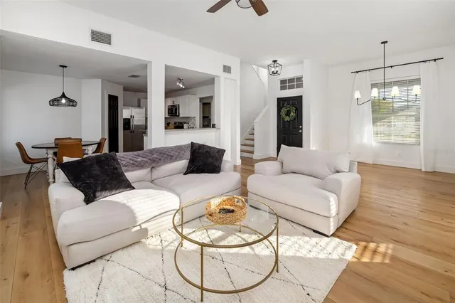 a spacious bedroom with a bed and wooden floor
