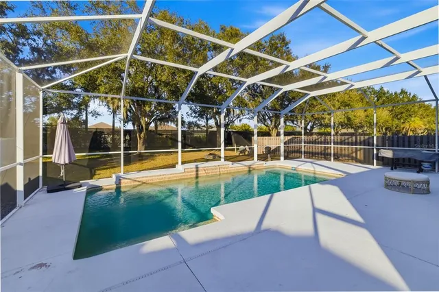an aerial view of a house with a swimming pool