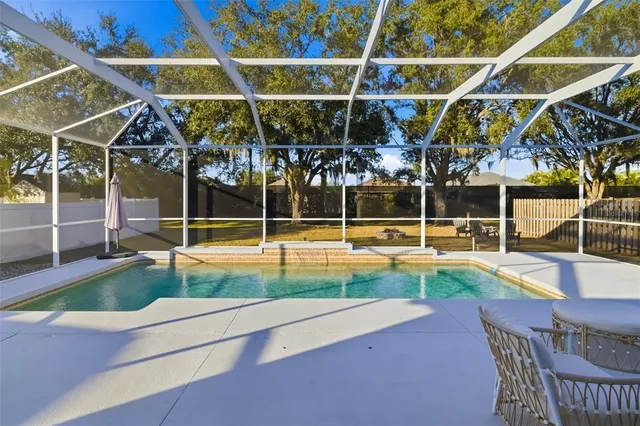 a view of a swimming pool with lounge chairs