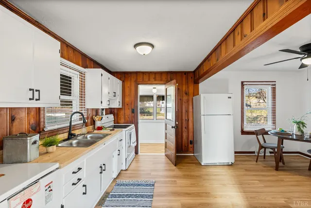 a large kitchen with stainless steel appliances granite countertop a sink and cabinets
