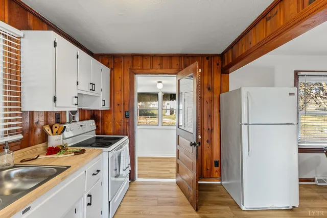 a kitchen with a refrigerator a sink and cabinets