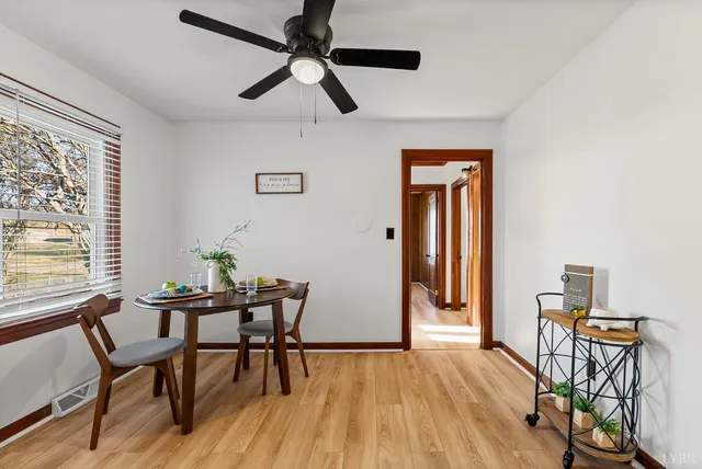 a dining room with furniture and window