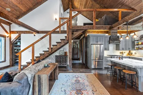 a dining room with wooden floor table and chairs