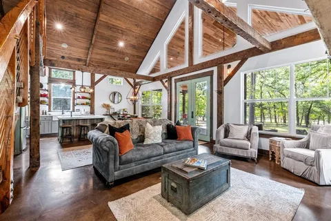 a living room with furniture a fireplace and a floor to ceiling window