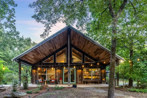 a view of wooden house with a large windows