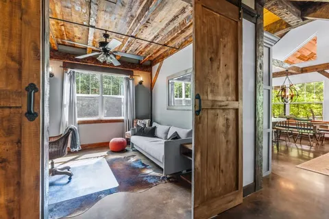 a view of a workspace with furniture and a window