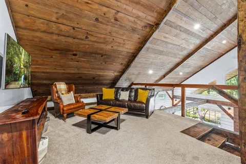 a bedroom with a bed a couch and a window