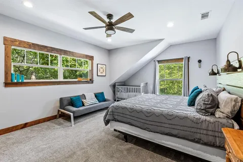 a bedroom with a bed and a couch