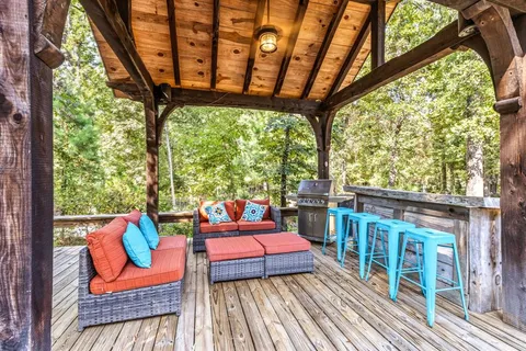 a view of a patio with a table chairs and a backyard