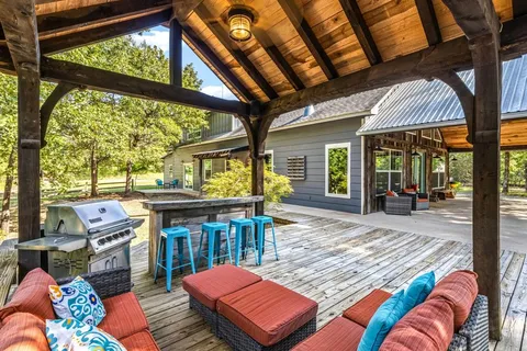 a backyard of a house with yard and outdoor seating