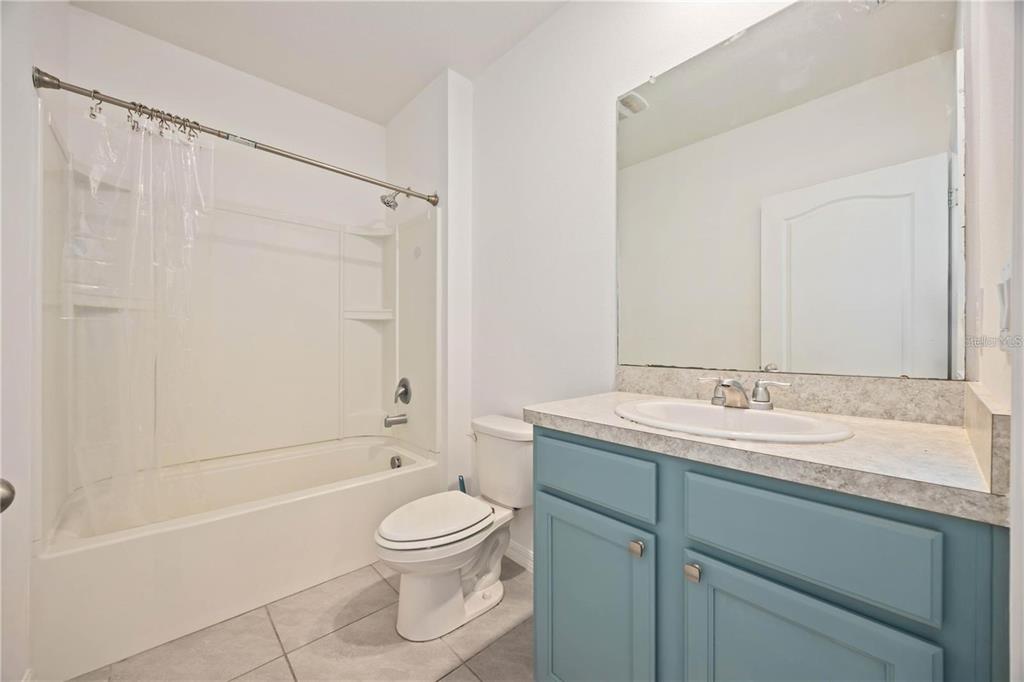 5473 Oro Valley Road Auburndale, FL 33823 - Photo 11 of 17 a bathroom with a granite countertop sink toilet and shower